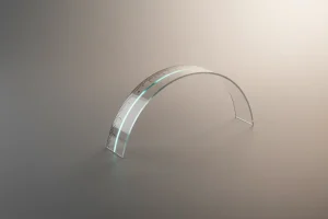 Curved clear ruler on a soft neutral background, symbolizing biased or leading employee survey design.