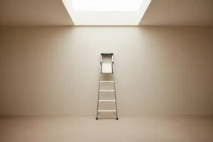 Minimalist ladder reaching toward a skylight in a soft neutral room, symbolizing professional growth.